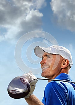 Smiling golfer holding golf club over shoulder