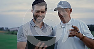 Smiling golfers using tablet device talking family online at country club course