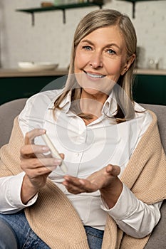 Smiling good-looking woman with blood sugar testing stick