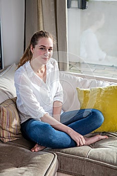 smiling gorgeous young woman sitting for happiness and wellbeing