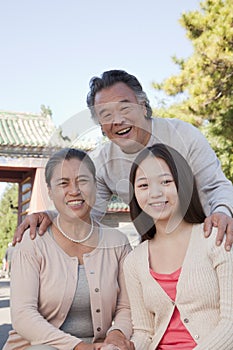 Smiling Granddaughter with grandparents, portrait