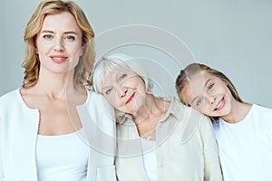 smiling granddaughter, mother, grandmother lying on