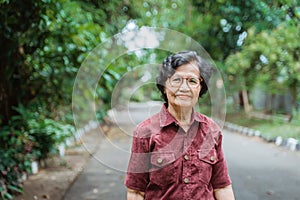 Smiling grandma with eyes glasses walking