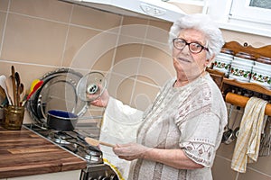 Smiling grandmother cooking in the kitchen