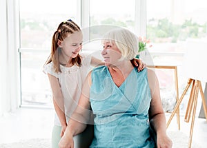 Smiling grandmother with cute granddaughter