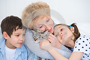 Smiling grandmother and grandchildren hugging