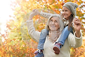 smiling grandmother and granddaughter