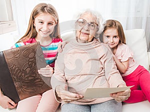 Smiling grandmother with granddaughters looking