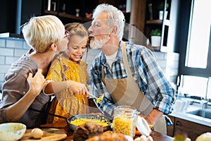 Smiling grandparents having breakfast with their granddaughter