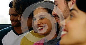 Smiling graphic designers discussing over papers stuck on wall