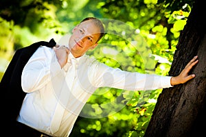 Smiling Groom and a big tree