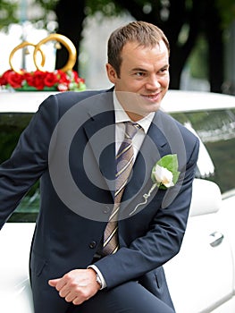 Smiling Groom on wedding Car limousine