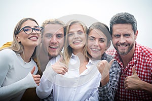 Smiling group of friends laughing with thumb up. Happy company students best friends making selfies. Group young people