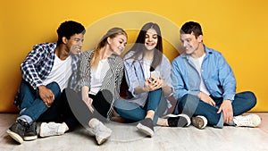 Smiling Group of Friends Sharing Content on a Smartphone