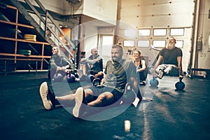 Smiling group of people relaxing together after a gym workout