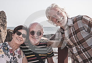 Smiling group of senior people enjoying sea excursion. Active lifestyle for three retired people