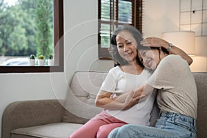 smiling grownup daughter hugging older mother. two generations concept, beautiful young woman embracing mature woman