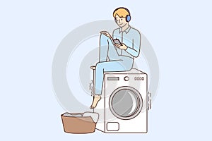 Smiling guy listen to music wait for laundry