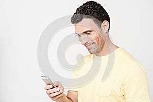 Smiling guy sending a text message