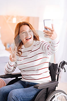 Smiling handicapped woman taking selfies