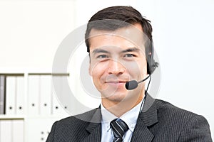 Smiling handsome businessman wearing microphone headset