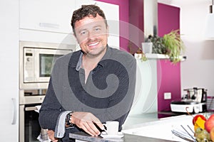 Smiling handsome forties man with coffee at home relax and lifestyle