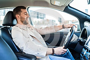 Smiling handsome man driving car.