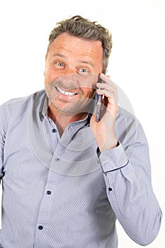 Smiling handsome man talking on a mobile phone isolated on white background