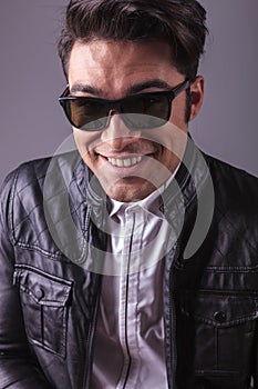Smiling handsome man wearing black sunglasses.