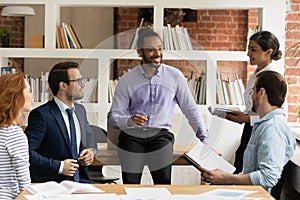 Young african american businessman holding negotiations meeting with partners.