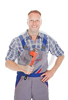 Smiling Handyman Holding Adjustable Wrench