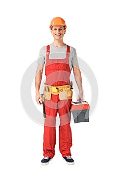 Smiling handyman in overalls holding toolbox