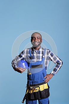 Smiling handyman wearing coveralls