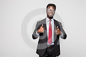 Smiling happy african black executive professional giving a thumbs up in studio