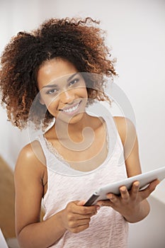 Smiling happy afro american woman using pc tablet at home.