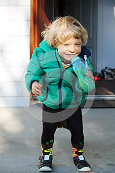 Smiling happy baby boy drinking juice