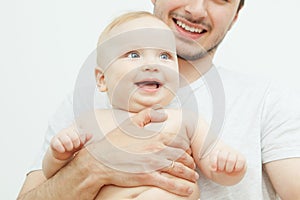 Smiling happy baby in father`s hand. Little enfant toddler