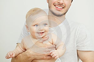 Smiling happy baby in father`s hand. Little enfant toddler