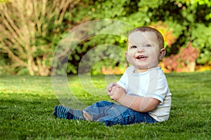 Smiling happy baby playing on the grass