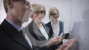 Smiling happy business woman discussing with partner plans, approves the deal