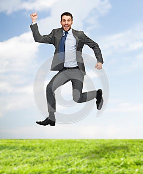 Smiling happy businessman jumping