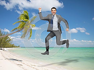 Smiling happy businessman jumping