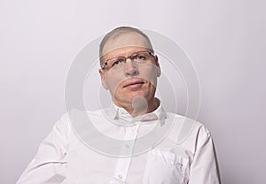 Smiling happy businessman looking staright. Friendly senior man in glasses