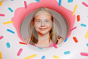Smiling happy child girl with inflatable ring swimming float closeup. Summer, vacation and leisure activity concept