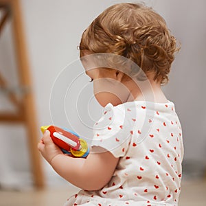 Smiling happy child. Portrait of little toddler girl, baby in diaper joyfully sitting and laughing isolated on