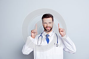 Smiling happy doctor in white coat with stethoscope isolated on