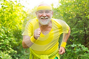 Smiling happy elderly man running. Be in motion. Age is no excuse to slack on your health. Elderly man practicing sports