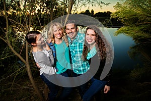 Smiling Happy Family by a Lake