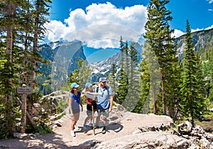 Smiling happy family relaxing on the hiking trail.