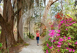 Smiling happy girl walking in beautiful garden on spring trip.